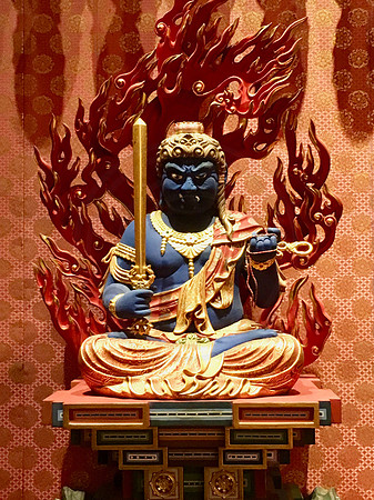 Little Buddha representing one zodiac sign among thousand others on a wall